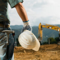 construction worker in front of work site