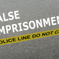 False Imprisonment written on road with police yellow tape