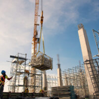 group of construction workers working with crane