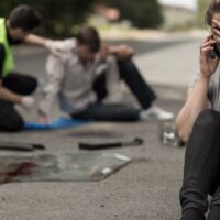 young female driver in despair after car accident