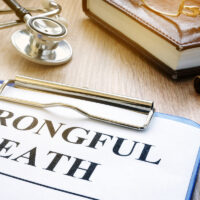 Wrongful death form and stethoscope on a table.