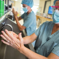 Two nurses washing their hands as hospitals are accessed by safety grade
