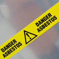 Asbestos yellow tape warning sign