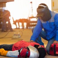 First aid training in the factory industrial. Welder accident in works and fainting in a factory industrial.