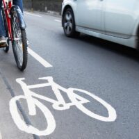 Man On Bike Using Cycle Lane As Traffic Speeds Past