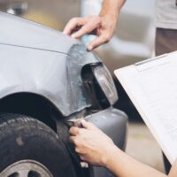 Insurance agent working during on site car accident claim proces