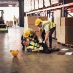 Industrial worker injured in the warehouse, factory while co-worker try to help, factory safety, construction zone, accident at factory work.