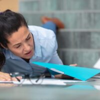 young businesswoman falling on stairs inside office building