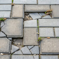 Damaged gray sidewalk tiles needing repair, sidewalk, broken, damaged, repair, outdated, perspective, paving Damaged gray sidewalk tiles needing repair, sidewalk, broken, damaged, repair, outdated, perspective, paving