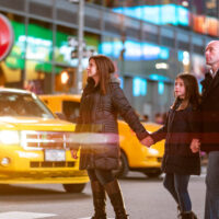 Family crossing Broadway in Times Square, New York City Family crossing Broadway in Times Square, New York City
