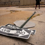 Fallen traffic sign on a concrete sidewalk street corner in the Hell’s Kitchen neighborhood of New York City.