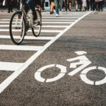 Bike lane street crosswalk with People ride bicycle crossing urban city lifestyle