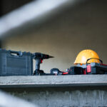 Construction tools and safety gear on shelf job site equipment display indoor close-up work environment