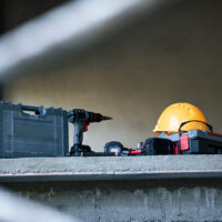 Construction tools and safety gear on shelf job site equipment display indoor close-up work environment Construction tools and safety gear on shelf job site equipment display indoor close-up work environment