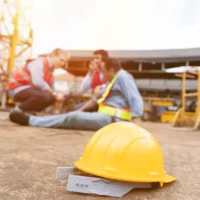 Men, construction, architect have accident during construction on site. Construction builder worker accident at construction site. Industrial accident. Health safe of work and safety first concept
