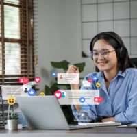 young-freelance-woman-using-laptop-checking-social-media